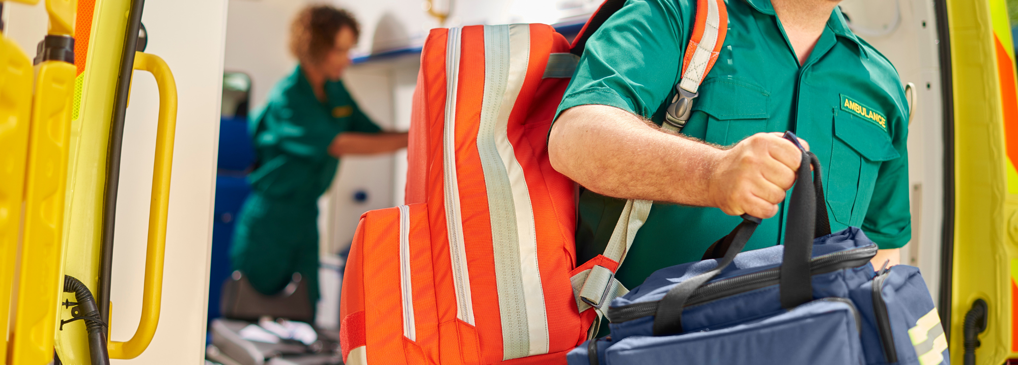 bypass numbers. ambulance clinician carrying bag out of ambulance.